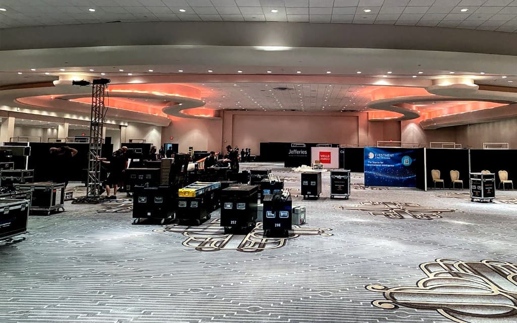 Crew managing full-show operations across a large ballroom floor