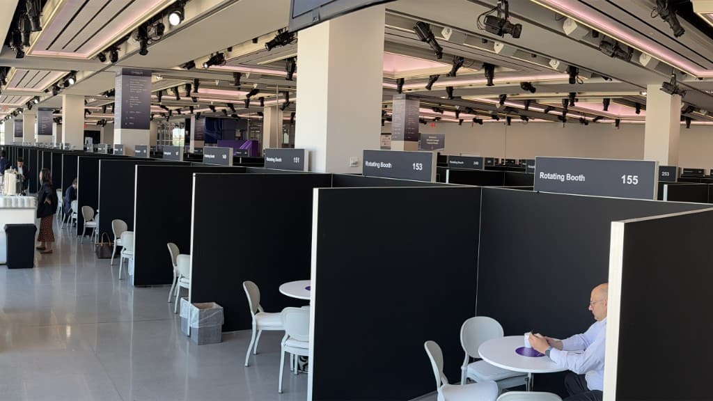 Convention hall with rotating meeting pavilion booths on the show floor