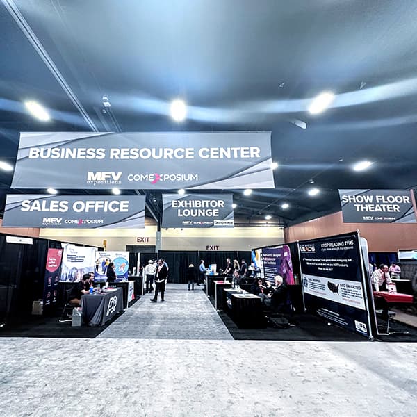 Show floor with Business Resource Center, Exhibitor Lounge, and service area signage