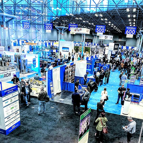 High-angle view of a busy convention show floor during active show days