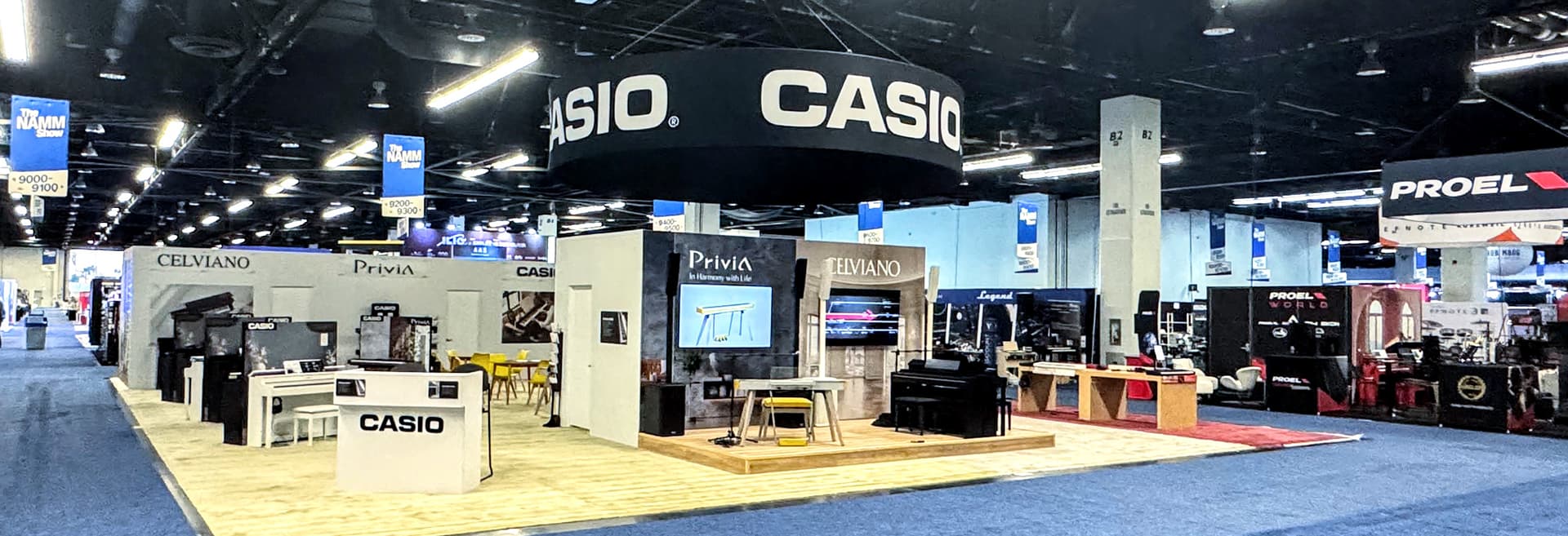 Casio trade show exhibit with hanging sign and digital piano displays on the show floor